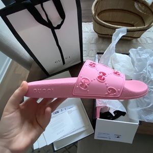 GUCCI slides, pink: “Women’s Rubber GG Slides”